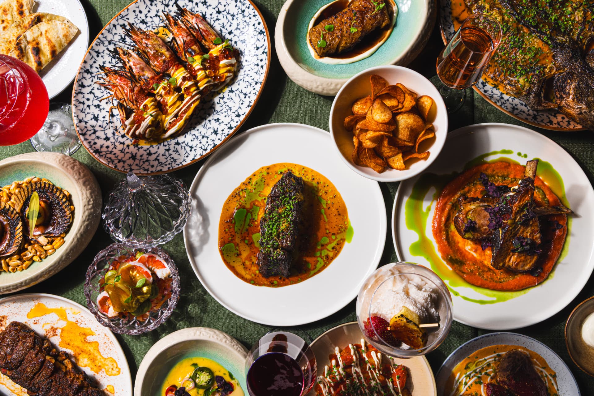Overhead flatlay of The Margin's signature dishes, wine and cocktails