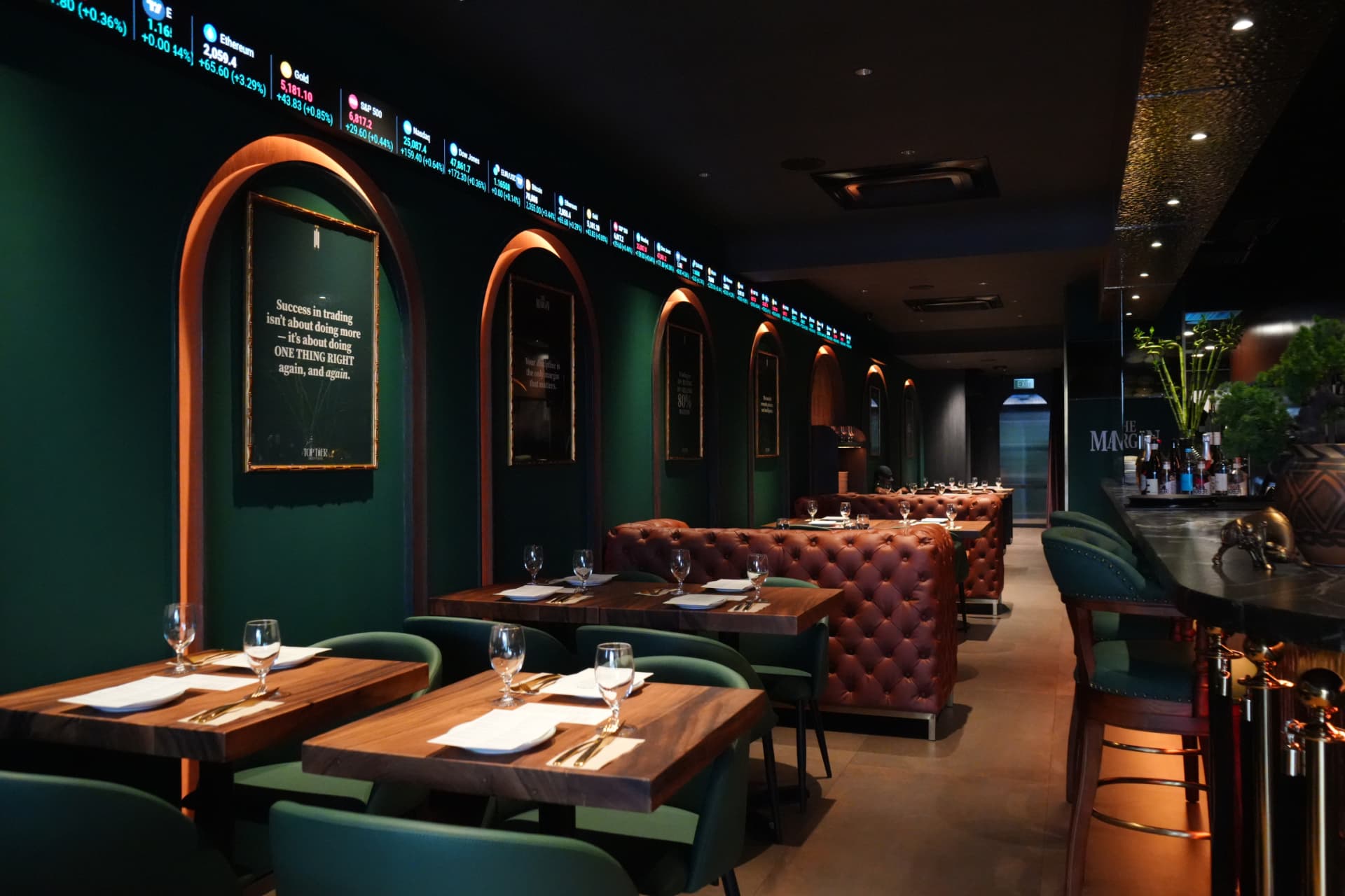 The Margin Singapore dining room with forest green arches, leather booths and warm wood tables